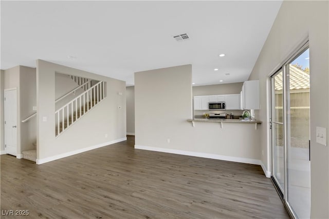 unfurnished living room featuring dark wood-type flooring