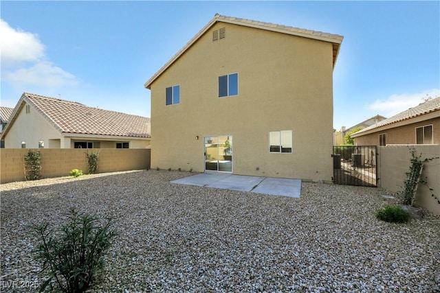 back of property with a patio