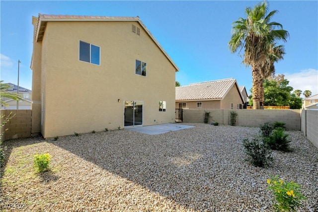 rear view of property featuring a patio area