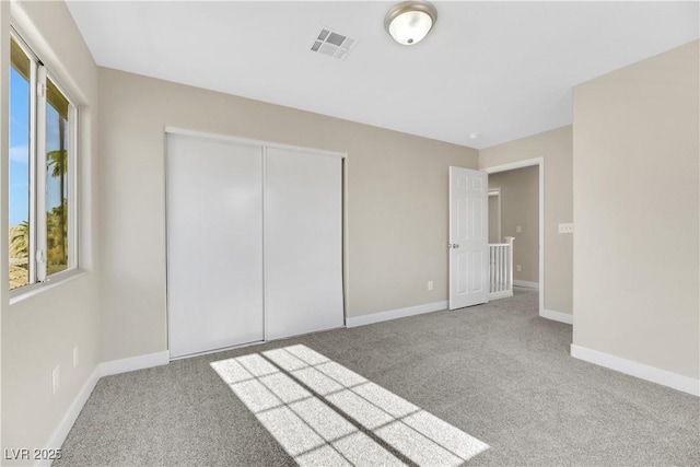 unfurnished bedroom featuring a closet and carpet