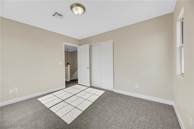 unfurnished bedroom with a closet and carpet