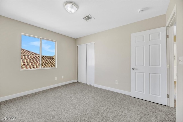 unfurnished bedroom featuring a closet and carpet flooring