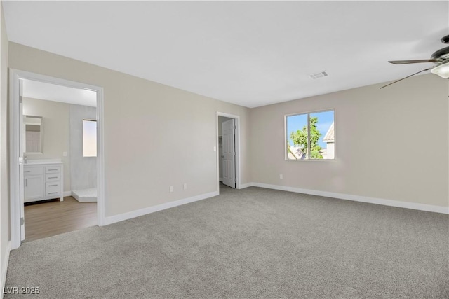 carpeted spare room featuring ceiling fan