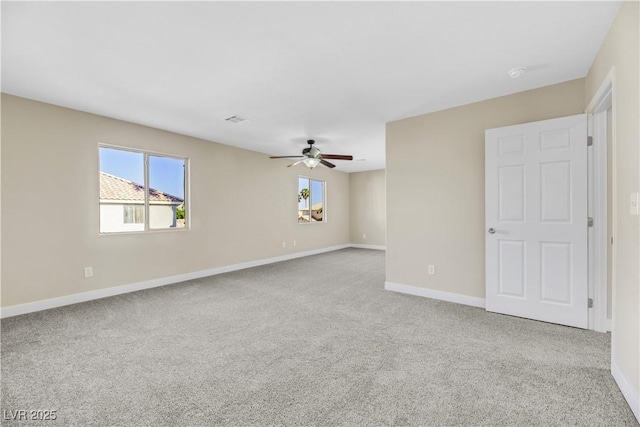 carpeted empty room featuring ceiling fan