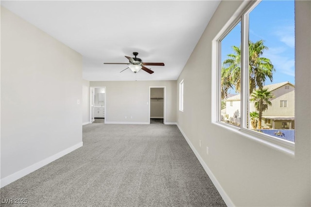 empty room with ceiling fan and carpet