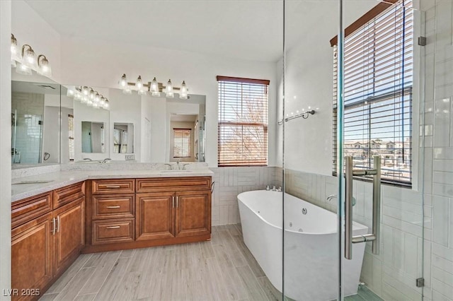 bathroom featuring vanity, tile walls, and plus walk in shower