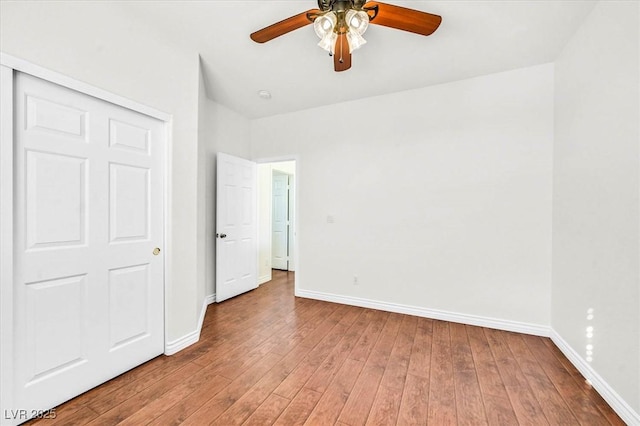 unfurnished bedroom with hardwood / wood-style floors, a closet, and ceiling fan