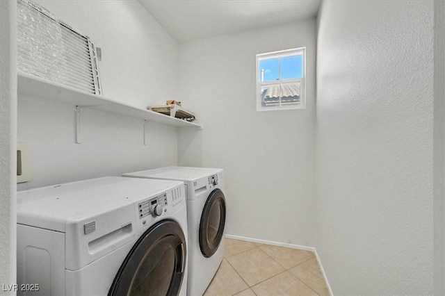 washroom featuring separate washer and dryer and light tile patterned floors