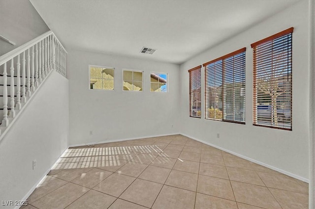 unfurnished room featuring light tile patterned floors