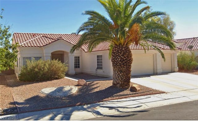 mediterranean / spanish home featuring a garage