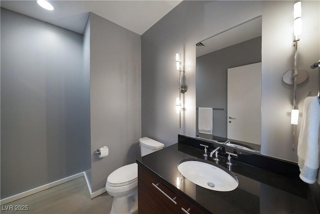 bathroom featuring toilet and vanity