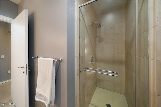 bathroom featuring a shower with shower door