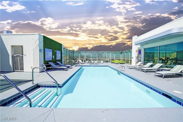 pool at dusk with a patio