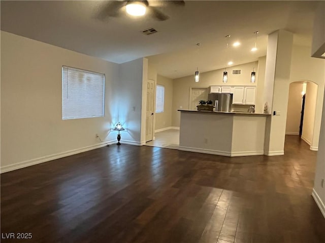 unfurnished living room with ceiling fan, dark wood-type flooring, and lofted ceiling