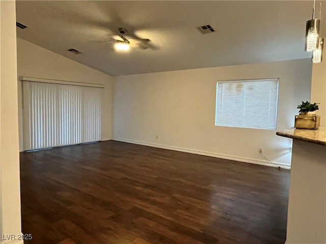 spare room featuring lofted ceiling, ceiling fan, and dark hardwood / wood-style flooring