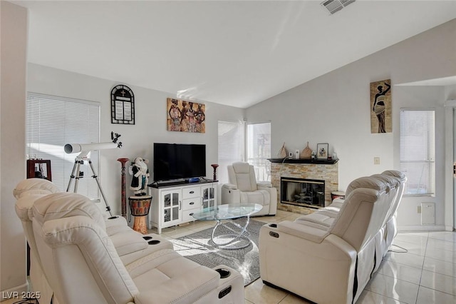 tiled living room featuring vaulted ceiling and a fireplace