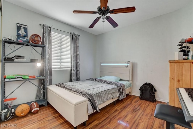 bedroom featuring wood-type flooring and ceiling fan