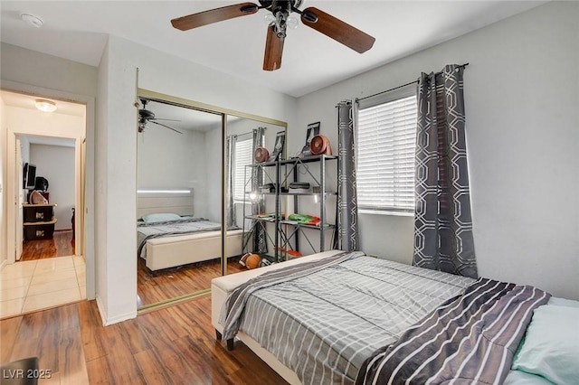 bedroom featuring ceiling fan, hardwood / wood-style floors, and a closet