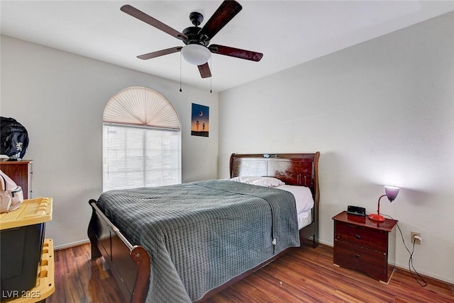 bedroom featuring ceiling fan and dark hardwood / wood-style flooring