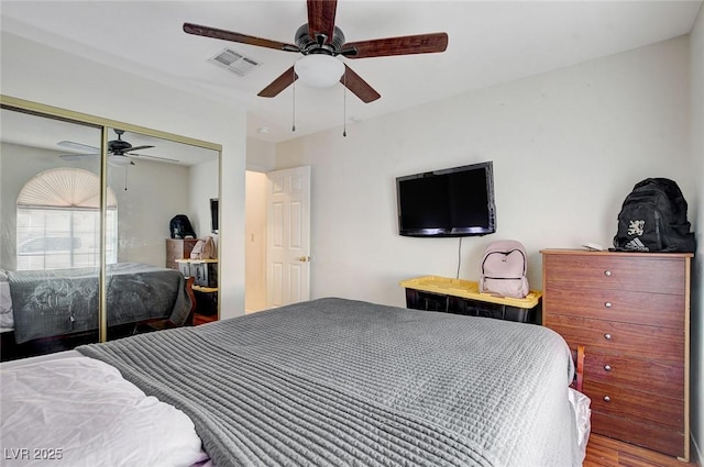 bedroom featuring wood-type flooring, a closet, and ceiling fan