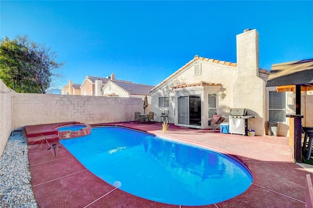 view of swimming pool with a grill, an in ground hot tub, and a patio area