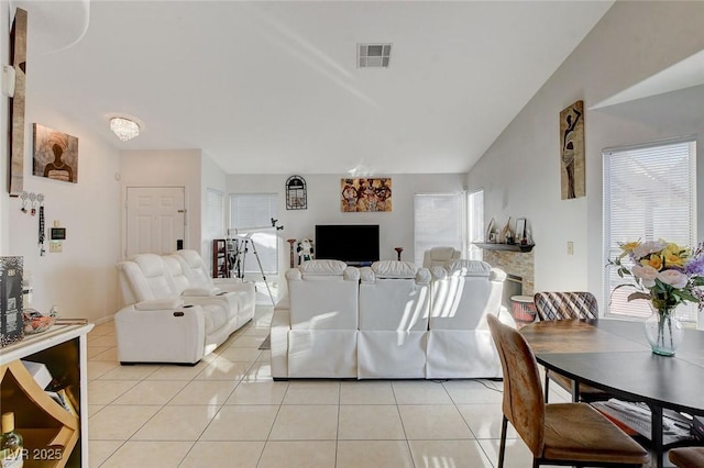 tiled living room with a notable chandelier