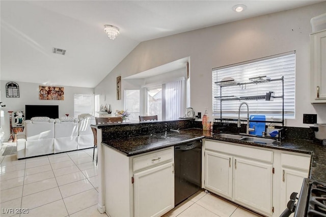 kitchen featuring dishwasher, light tile patterned floors, white cabinetry, dark stone countertops, and sink