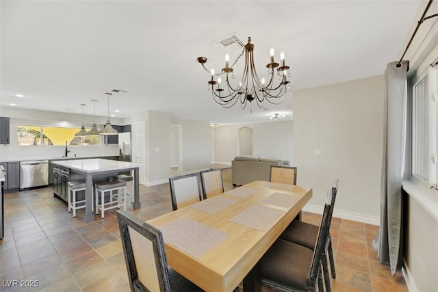 dining room with sink and a chandelier