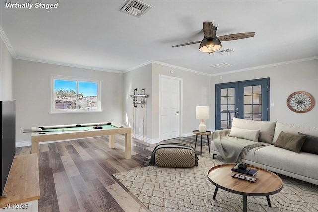 living room featuring wood-type flooring, french doors, billiards, ornamental molding, and ceiling fan