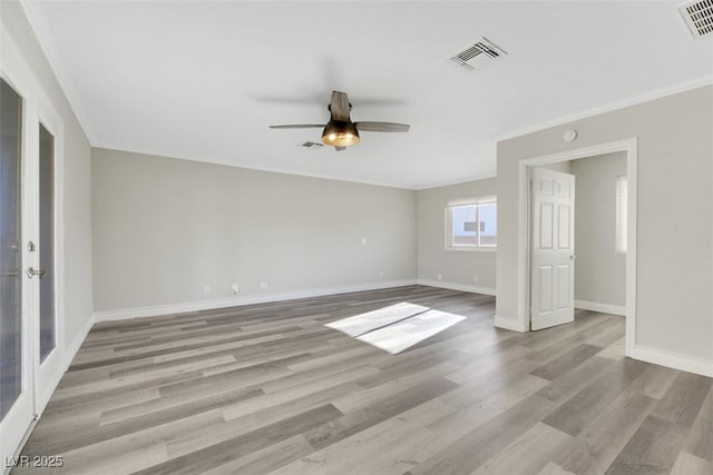 empty room with light wood-type flooring, ceiling fan, crown molding, and french doors