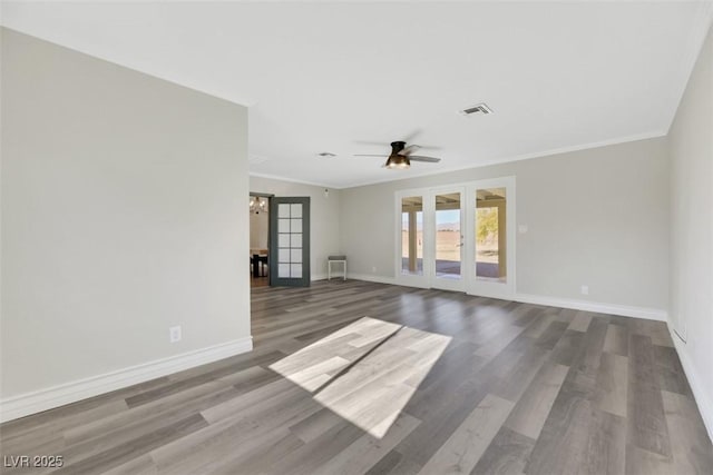 unfurnished room with ceiling fan, hardwood / wood-style flooring, ornamental molding, and french doors