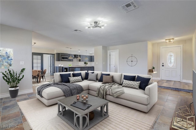 living room with a healthy amount of sunlight and an inviting chandelier