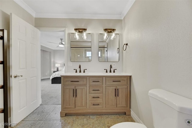 bathroom with ceiling fan, toilet, vanity, and crown molding