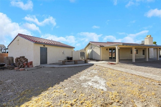 rear view of house with a patio area and cooling unit