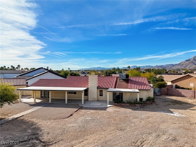 view of front of property with a patio area and a mountain view