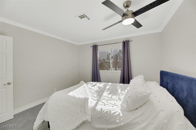 bedroom with ceiling fan, carpet, and crown molding