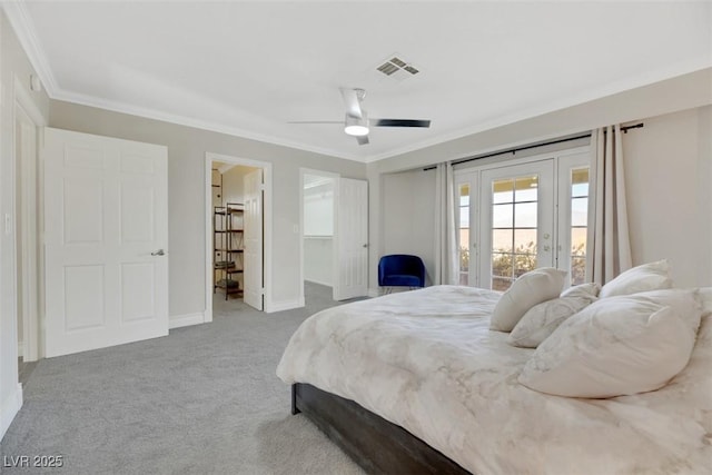 bedroom featuring ceiling fan, access to exterior, crown molding, light carpet, and a walk in closet