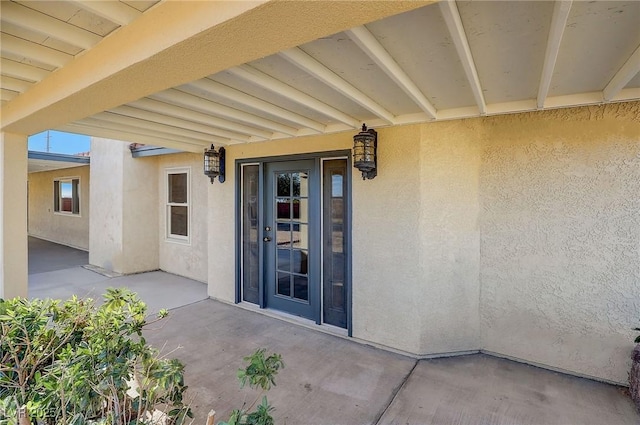 entrance to property featuring a patio area