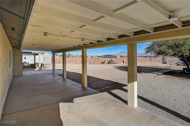 view of patio / terrace featuring ceiling fan and a mountain view