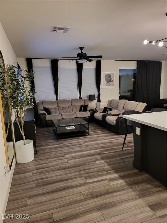 living room with ceiling fan and hardwood / wood-style floors