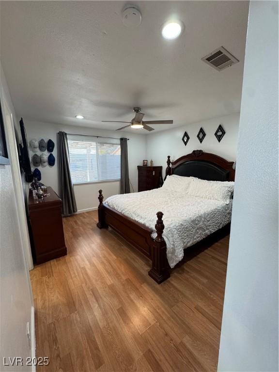 bedroom with wood-type flooring and ceiling fan