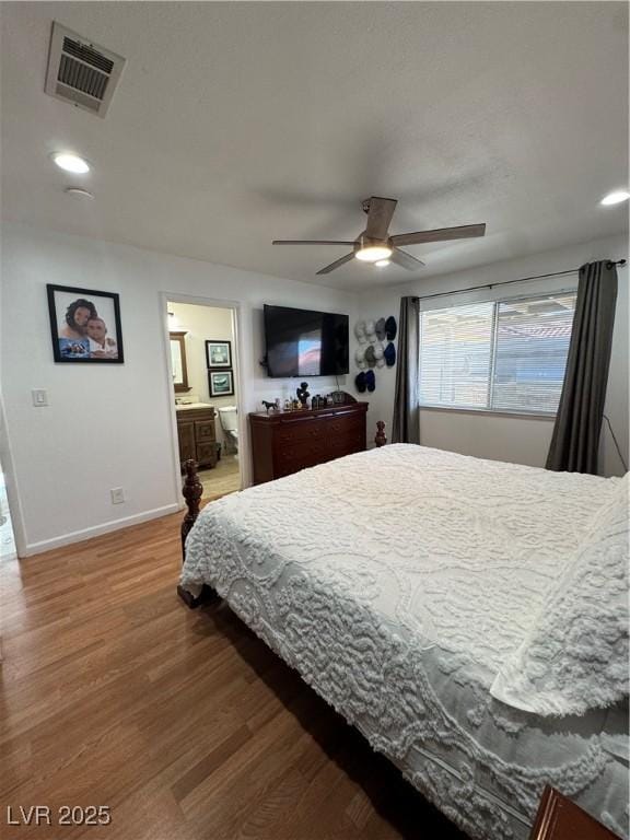 bedroom featuring ceiling fan, connected bathroom, and wood-type flooring