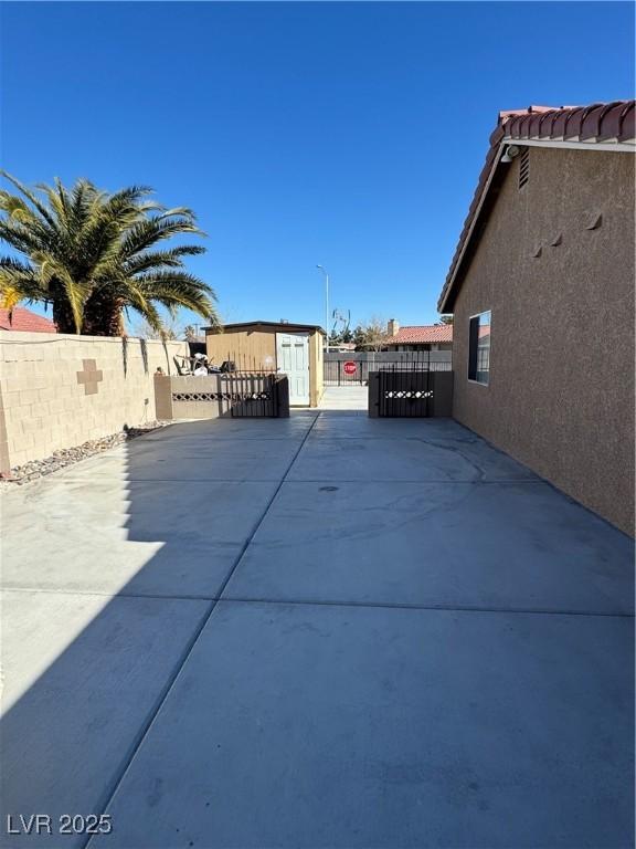 view of patio featuring a storage unit