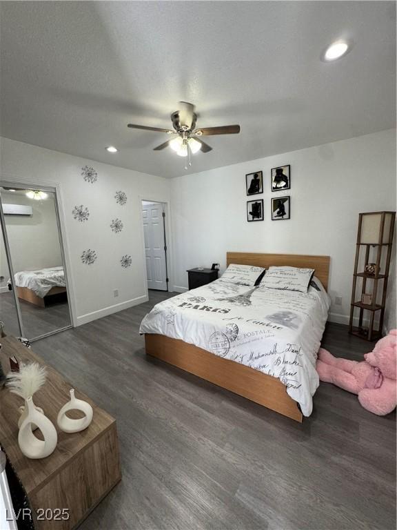 bedroom with a closet, ceiling fan, a textured ceiling, and dark hardwood / wood-style floors