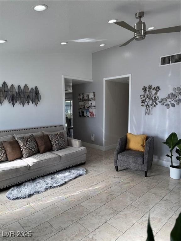 living room with ceiling fan and lofted ceiling