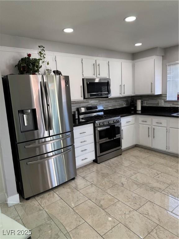 kitchen featuring white cabinets, appliances with stainless steel finishes, and backsplash