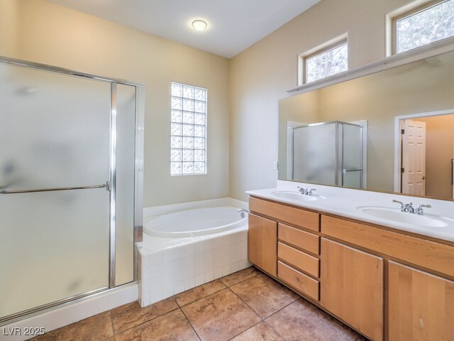 bathroom featuring independent shower and bath, tile patterned flooring, and vanity