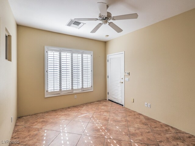 unfurnished room with ceiling fan and light tile patterned floors