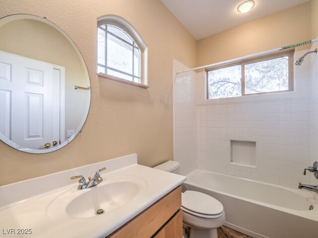 full bathroom featuring toilet, shower / tub combination, a healthy amount of sunlight, and vanity