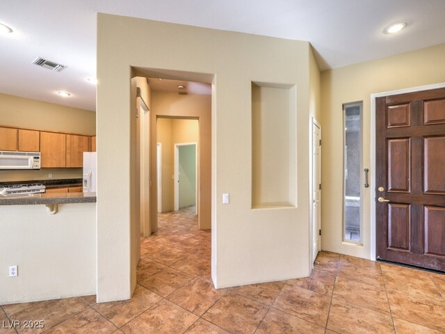 entrance foyer featuring light tile patterned flooring